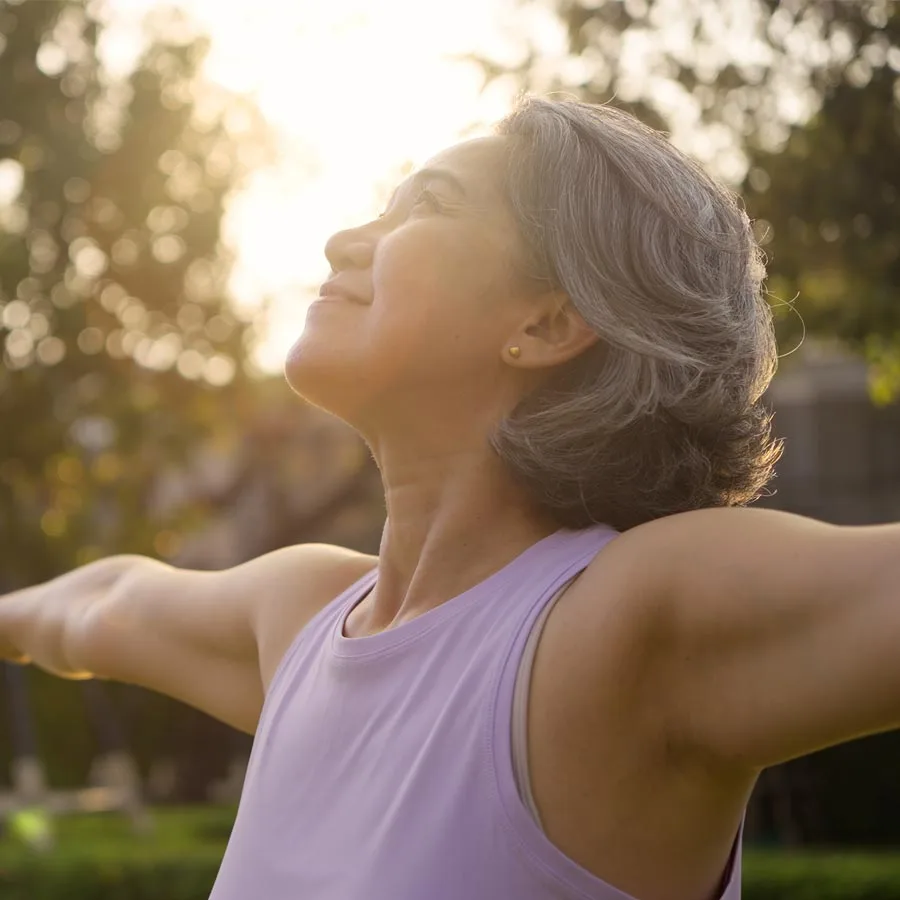 Asia adult aged people middle age mindful happy old woman open arm yoga deep calm stress relief outdoor nature public park sun light self...